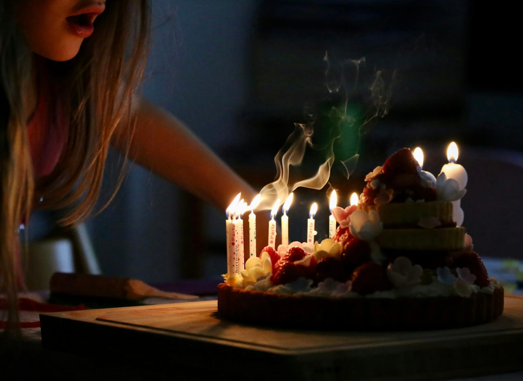 woman in white tank top holding lighted candles ( Dominican Baking )